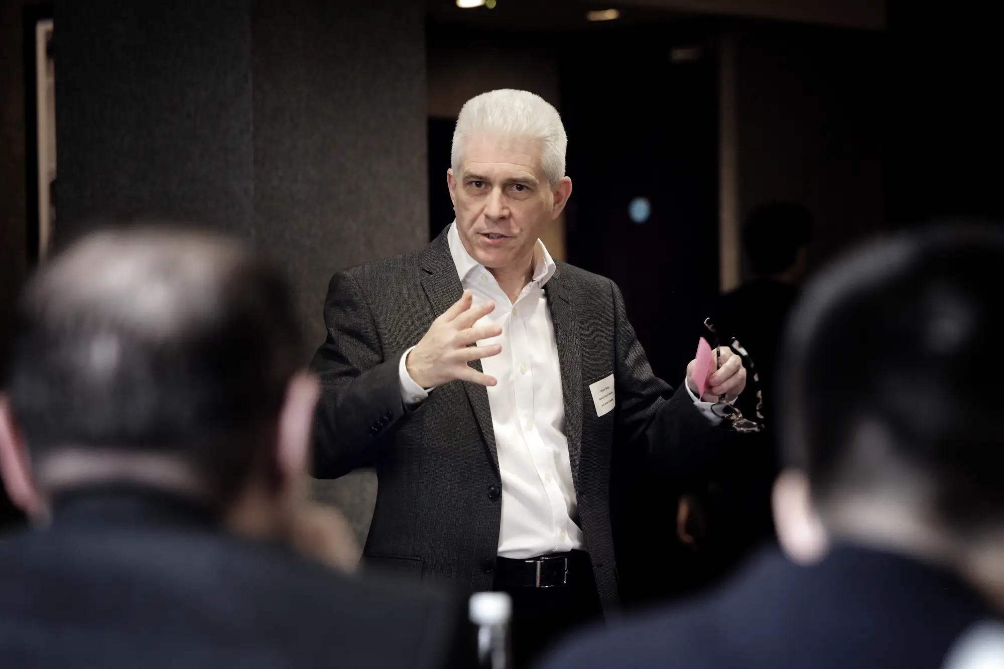 Senior executive speaking passionately during corporate team meeting