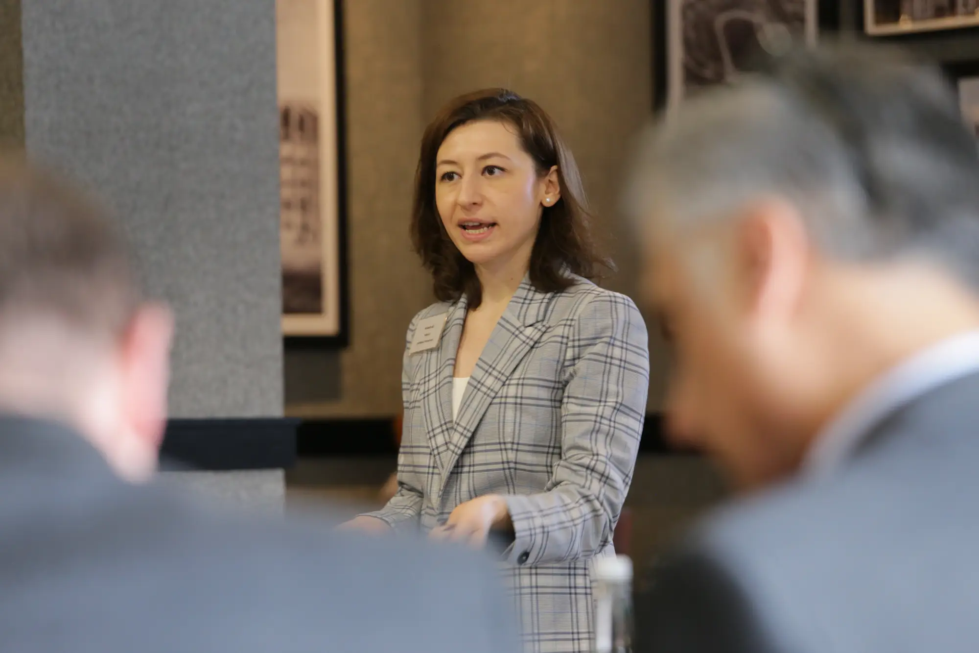 Woman presenting ideas during team meeting in modern office